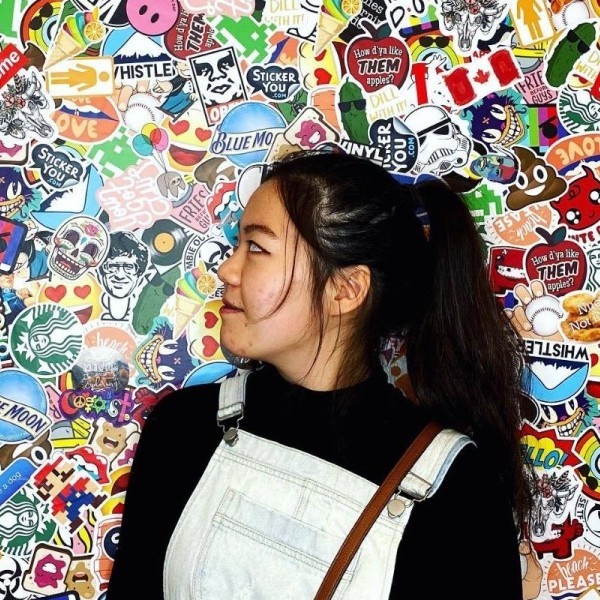 Emily Lin in front of a sticker board