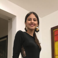 woman in black shirt and big earrings